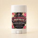 Blushing Bouquet natural deodorant in a white tube with floral label on a clean ivory background